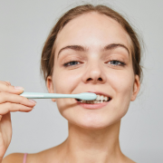 fair-skinned woman brushing teeth