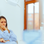 woman in dentist chair with toothache